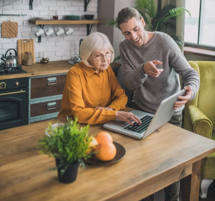 happy seniors using laptop tablet after tech help Satisfied seniors with reliable home WiFi after support Attleboro MA